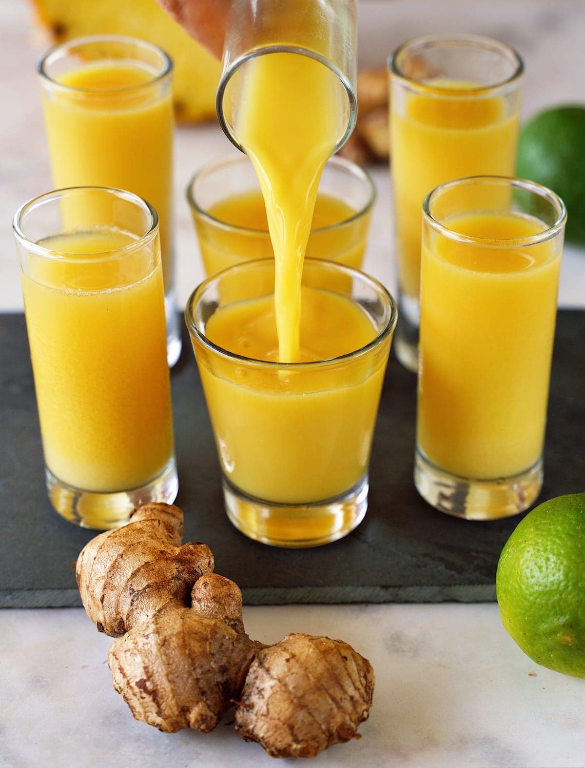 pouring-ginger-lime-juice-in-a-shot-glass